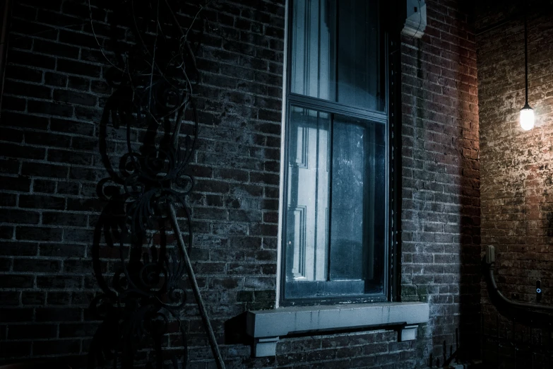 a light shines brightly in the window of an old building