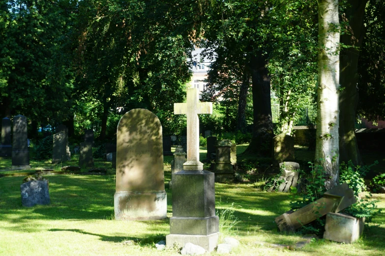 a cemetery with headstones in grass