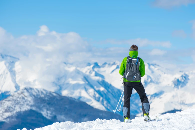 a man standing on top of a snow covered hillside