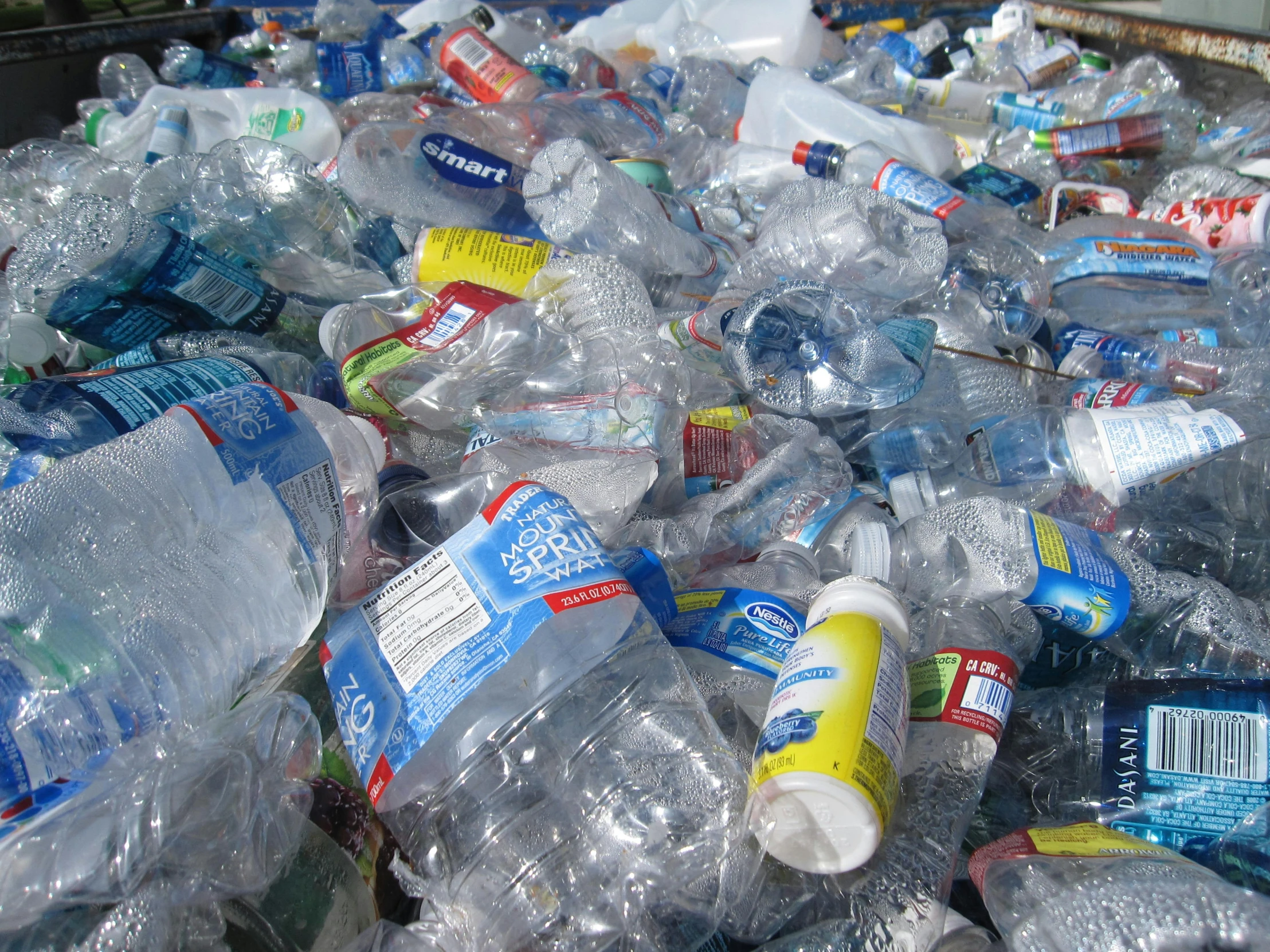 some plastic water bottles are lined up in a bin