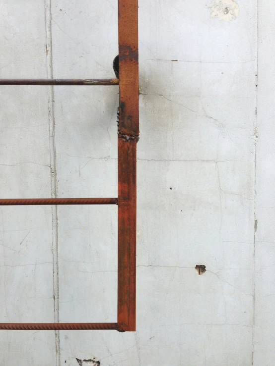 rusted steel bars are seen along the side of a building