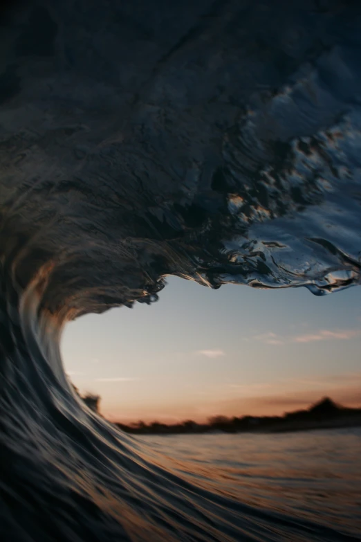 a picture taken looking at the inside of an ocean wave