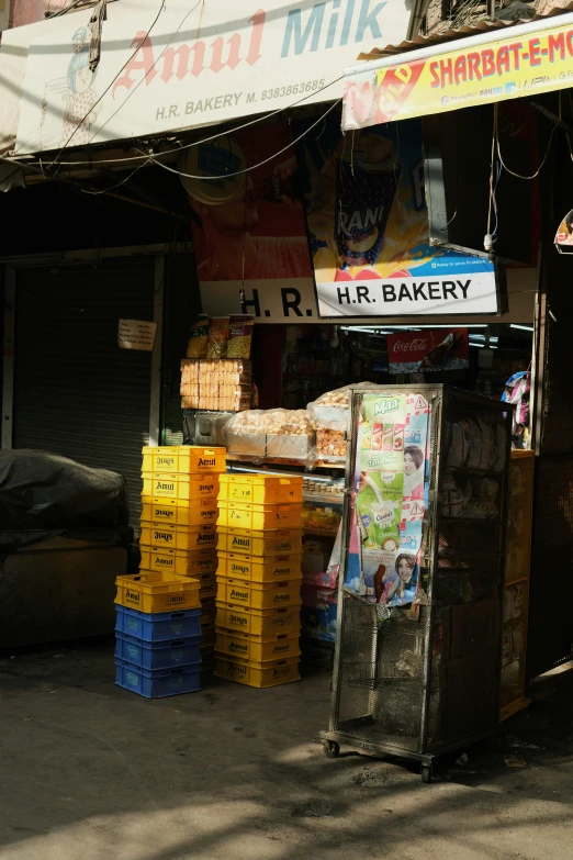 two stacks of plastic boxes stacked on top of each other in front of a market