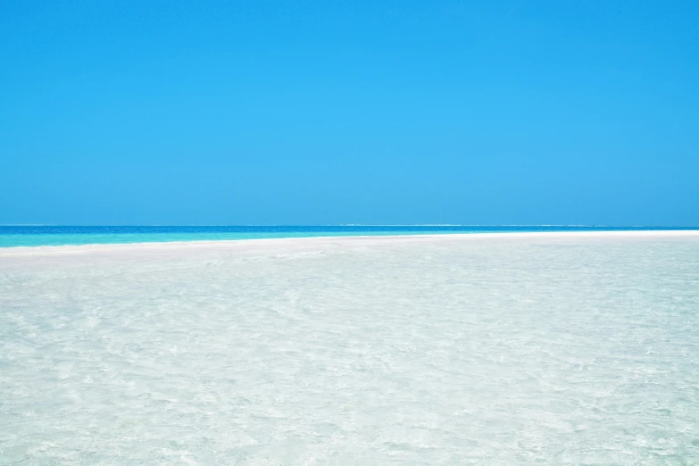 an ocean and beach area with white sand