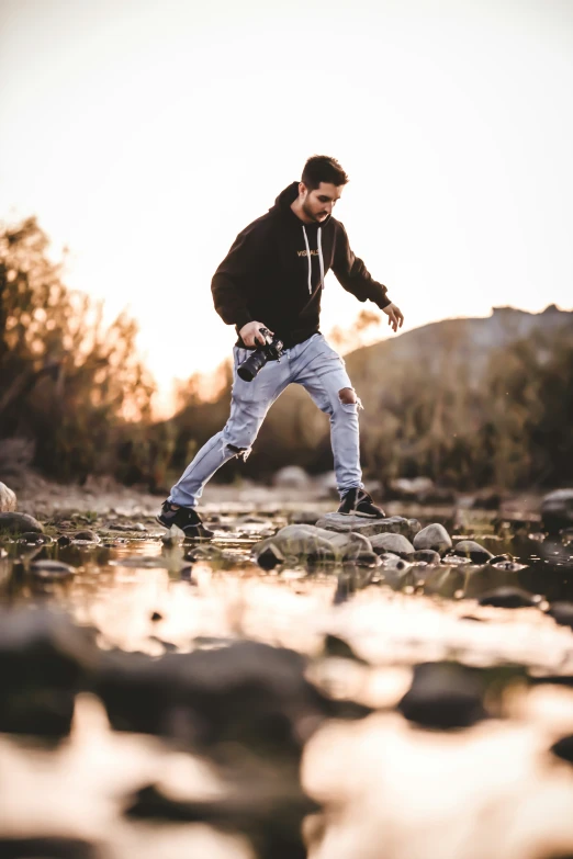 a man standing on rocks in the water