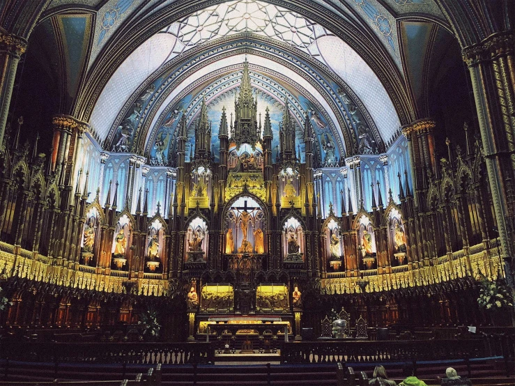 the interior of an ornate cathedral decorated with gold, silver and blue paint