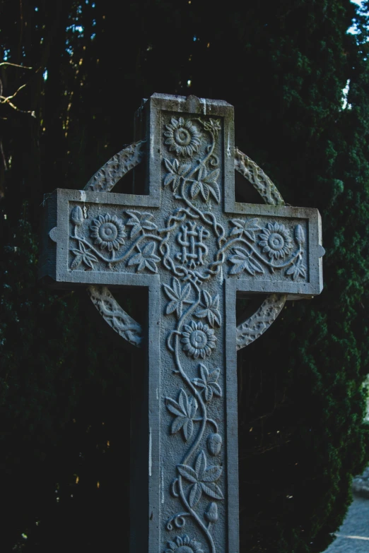 a gothic cross is adorned with designs and roses