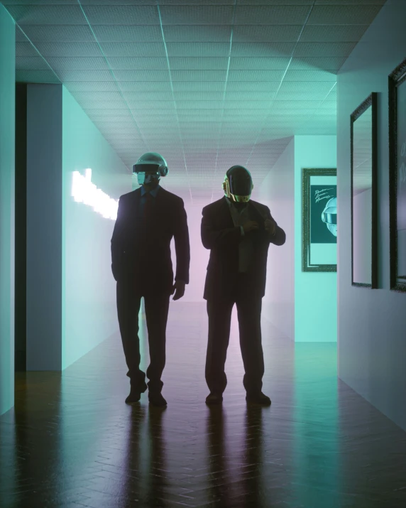 two people in suits walking in an empty room