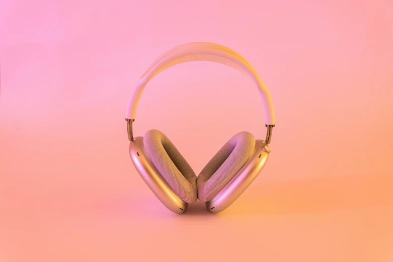 a pair of gold headphones with pink and yellow colors