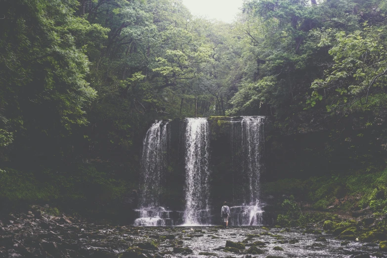 a waterfall cascading in between two smaller ones