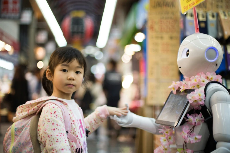 a girl is next to a robot