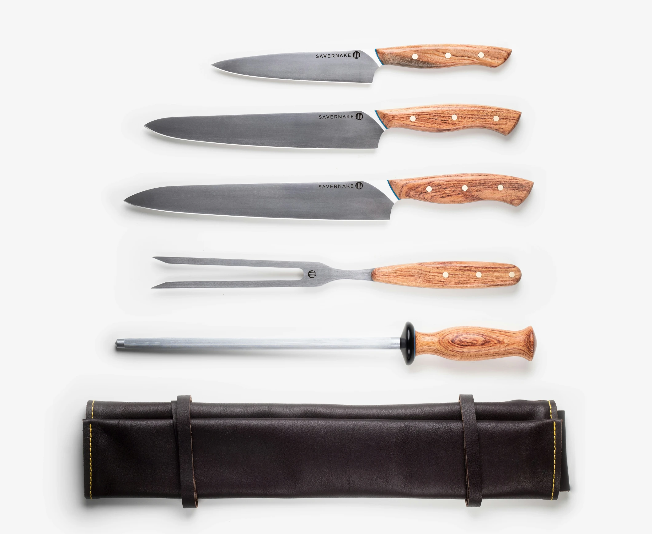 six knives are lined up on a white table