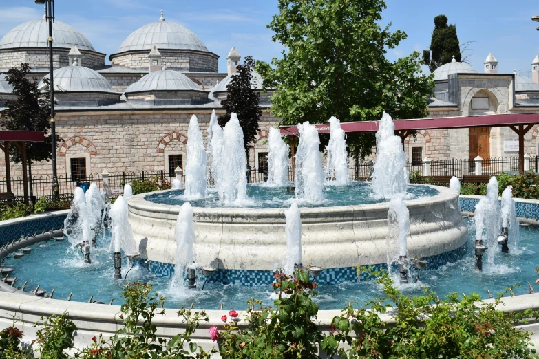 many small fountains are in a garden