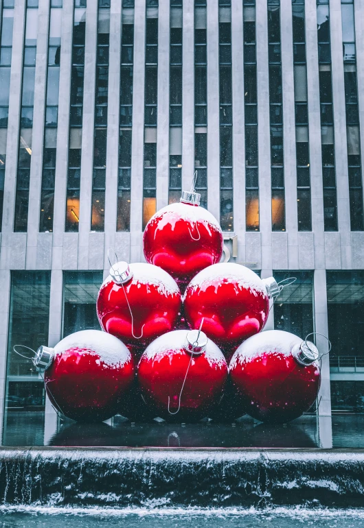 red ornament decorations are attached to a metal pole