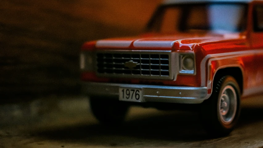 a small model truck sitting in the spotlight