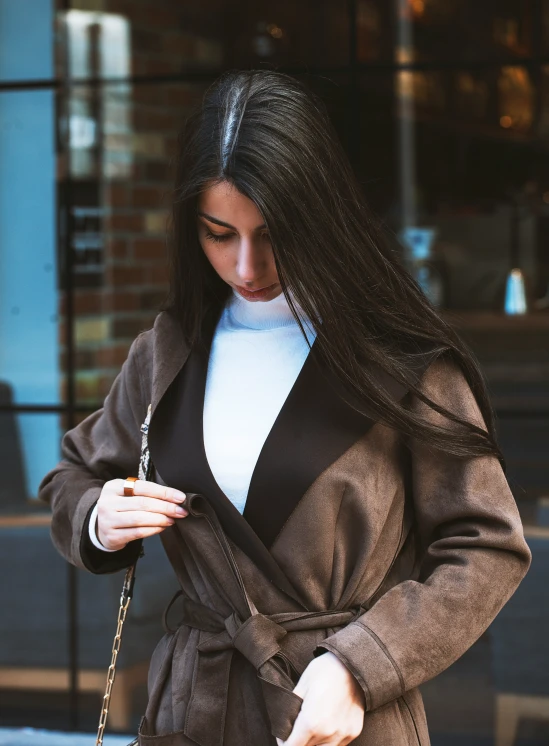 a woman is holding an item on a street