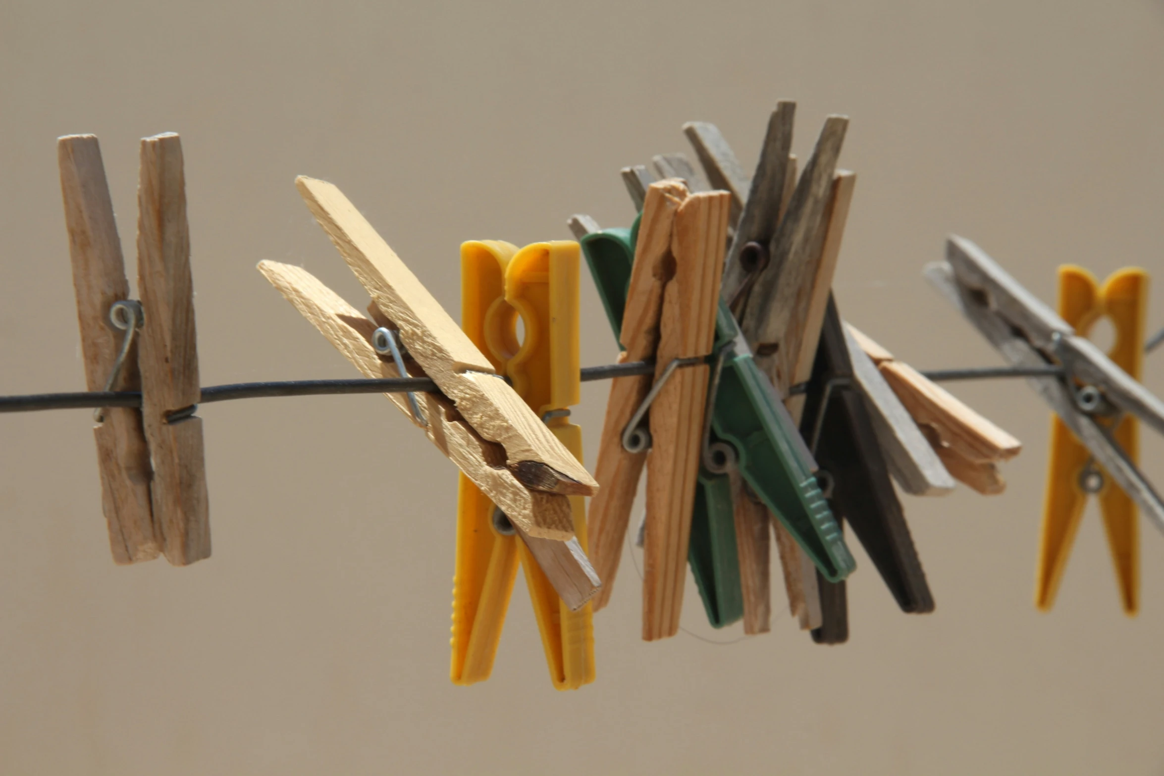 clothes pins with pairs of scissors hang out of a line