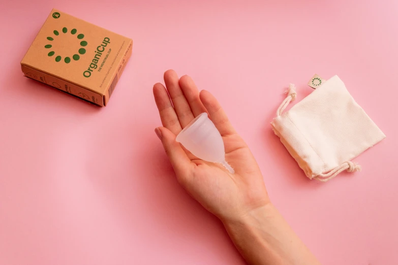 someone's hand wiping off the wipe near an unwrapped box of tissues