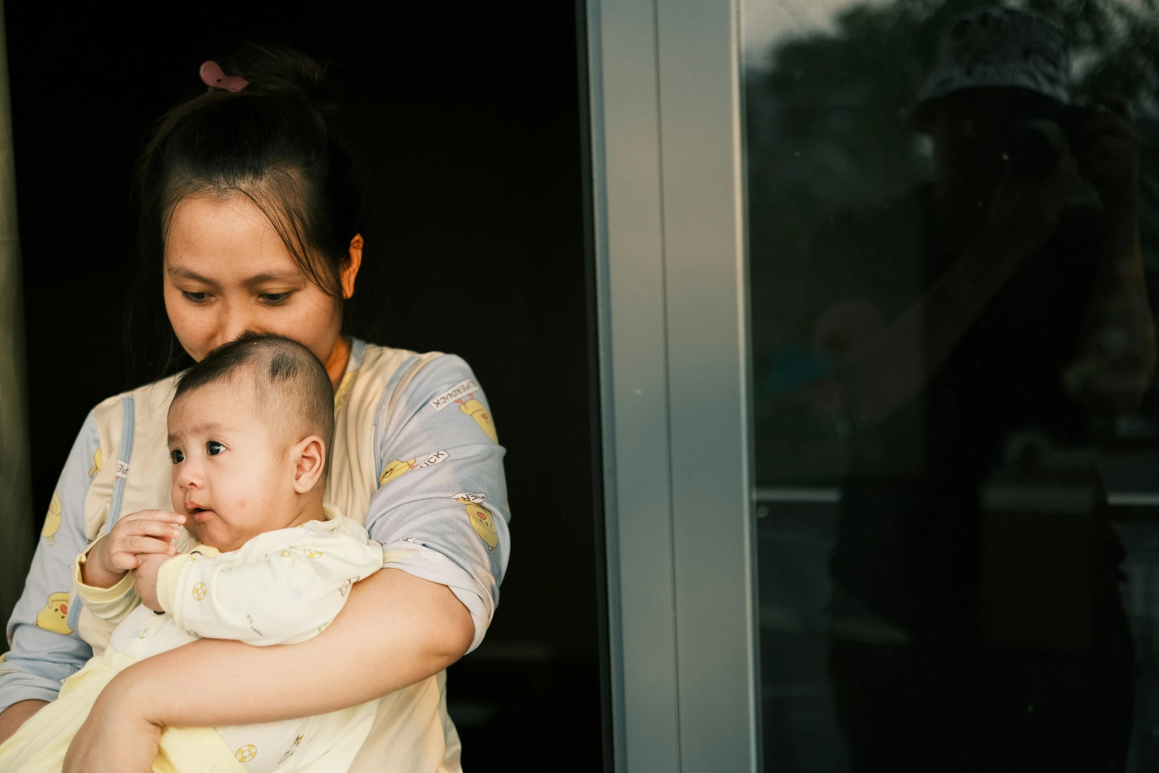 there is a woman holding a baby in her arms