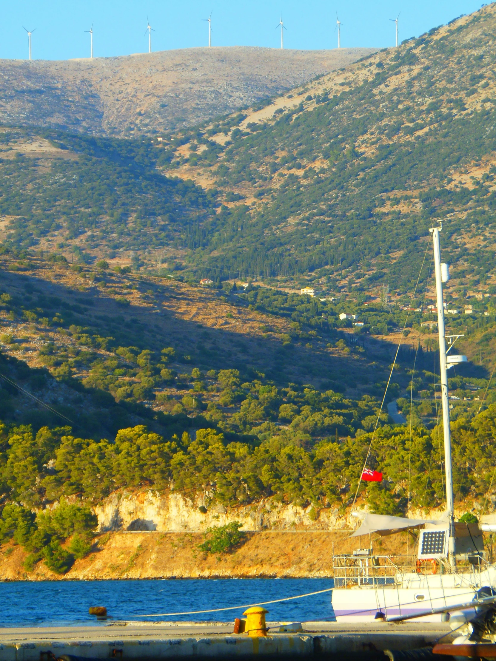 a view of a mountain top and a boat docked