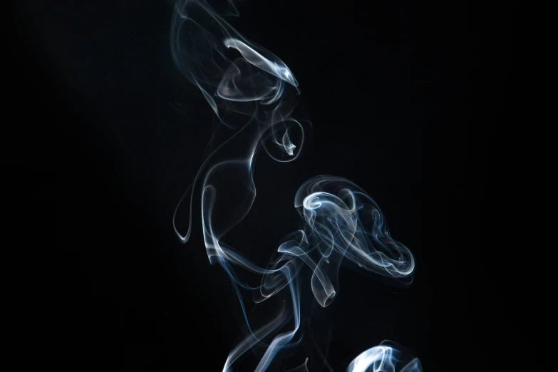 some white smoke that is coming out from some cigarette