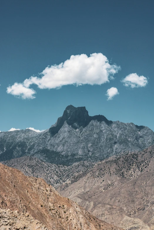 the view of the mountains from the top of the hill