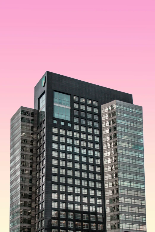 a tall black and gray building next to the sky