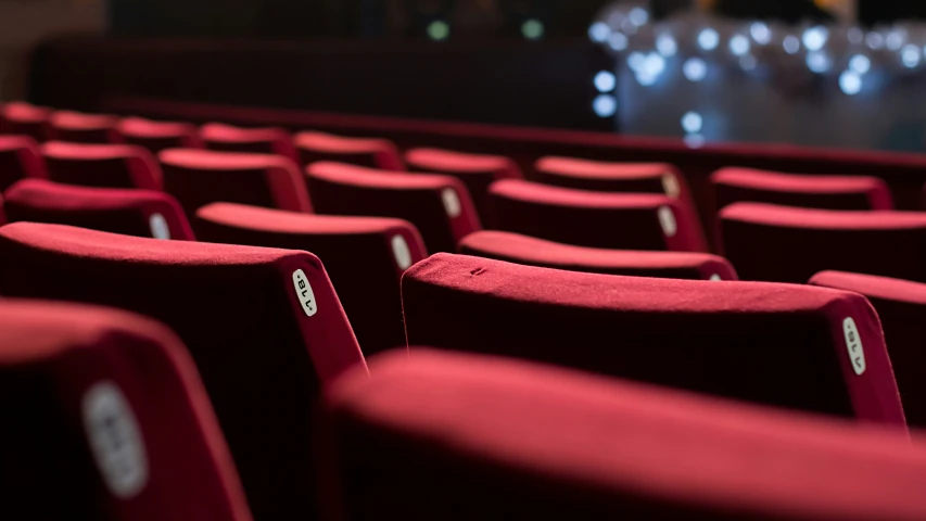 rows of chairs in a theatre with a projection screen