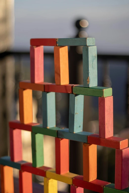 a multi colored set of blocks sits near a pole