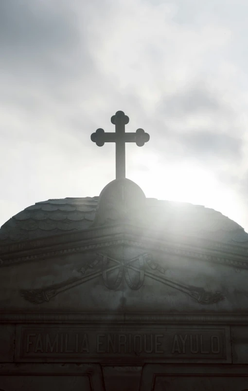 the sun shines brightly through clouds over a large church