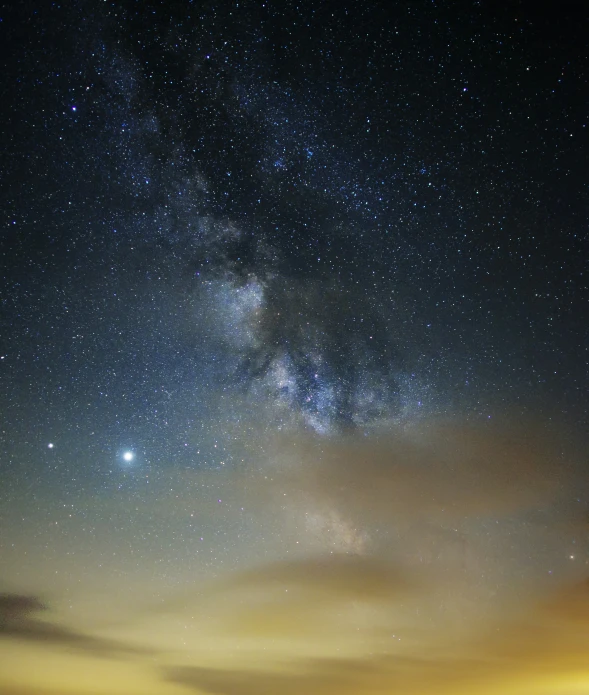 a night sky filled with stars, a field, and a large sky filled with stars