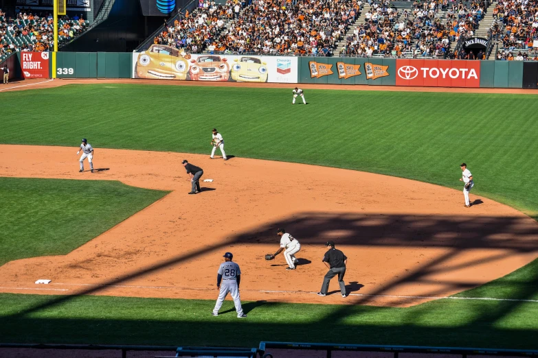 a base ball game in progress as the batter gets ready to hit