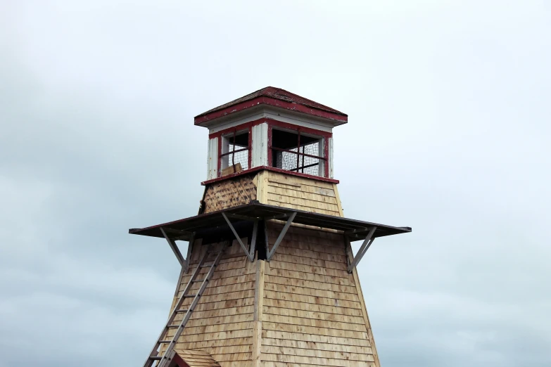 a brown and red clock tower on a cloudy day