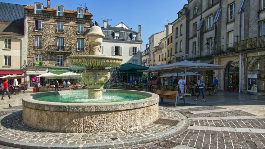 a fountain in a plaza surrounded by buildings