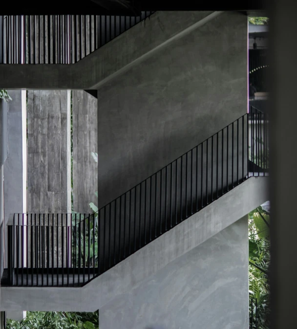 a skateboarder is standing between two sets of stairs