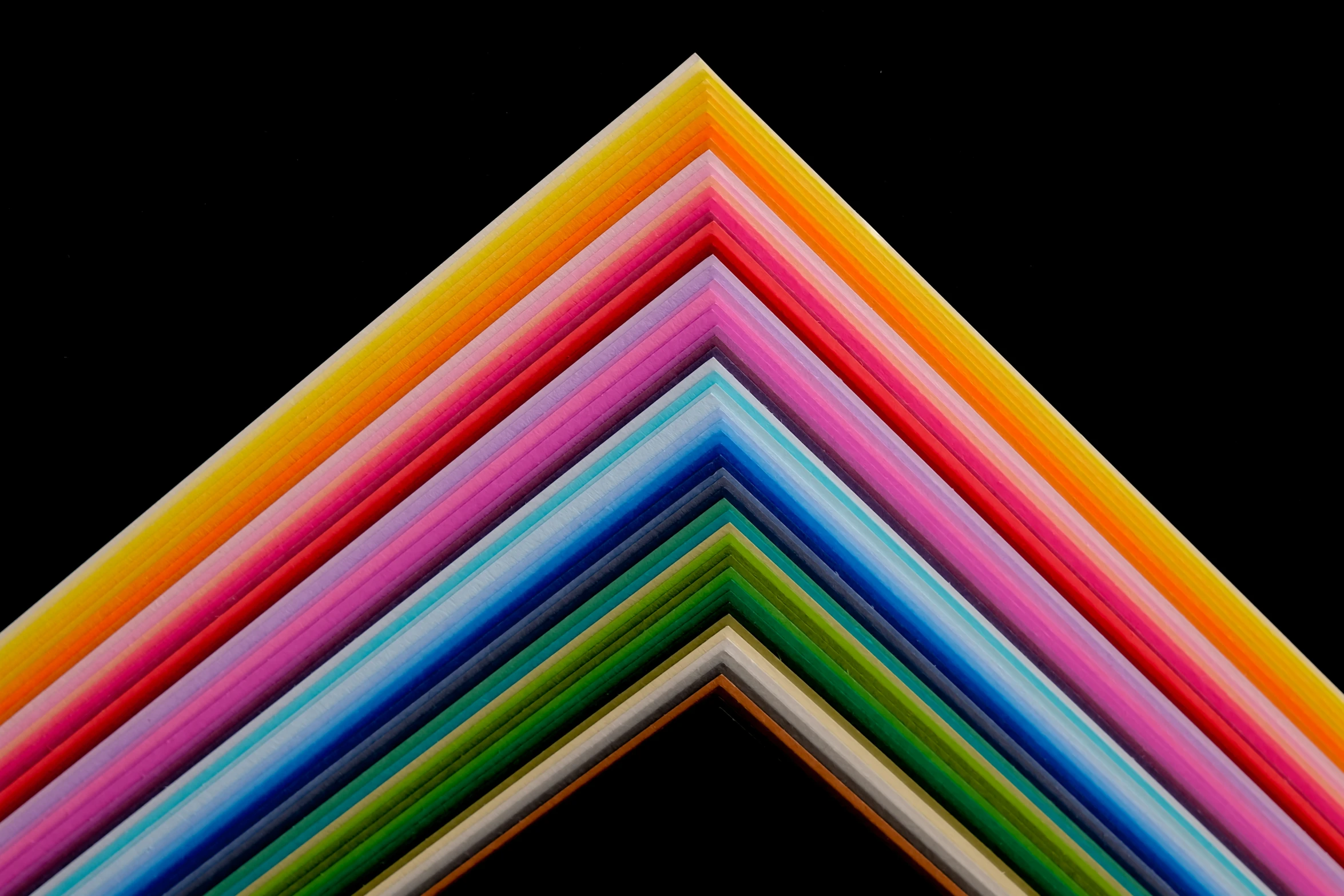 a large stack of colored paper squares arranged in a triangle