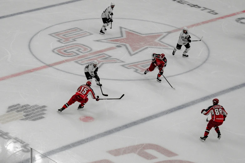 two teams of men on the ice in hockey jerseys