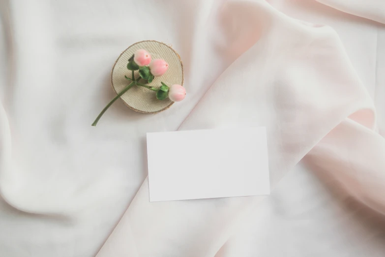 a cup and a paper on top of fabric