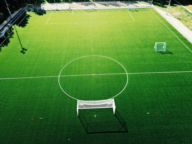 a picture of a small soccer field with a goal on the lawn