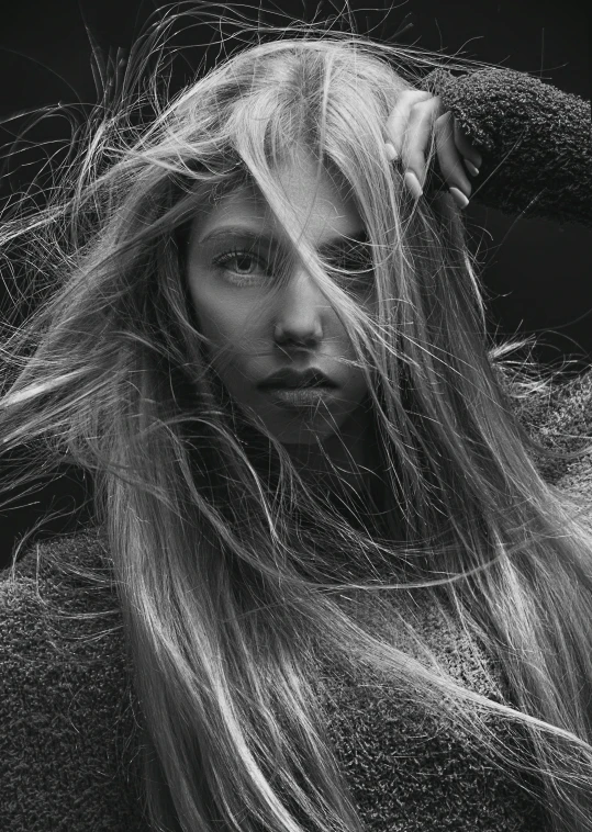 a woman with long hair blowing her hair