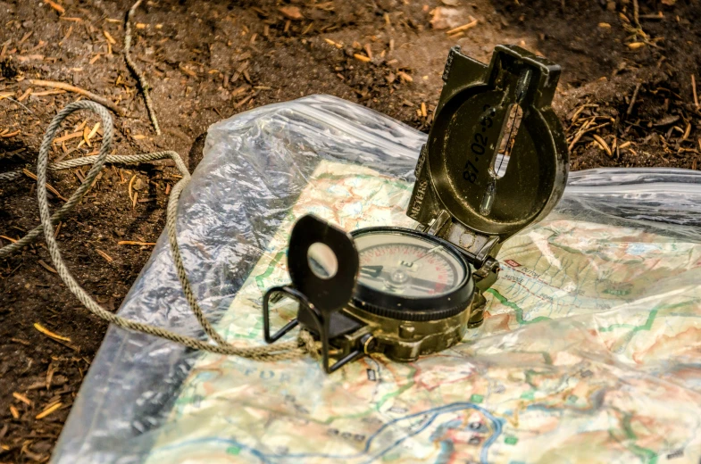 a compass and an open box with some wire on top