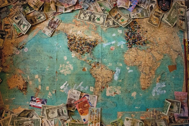 an artistic painting of a world map with currency notes and pos all over it