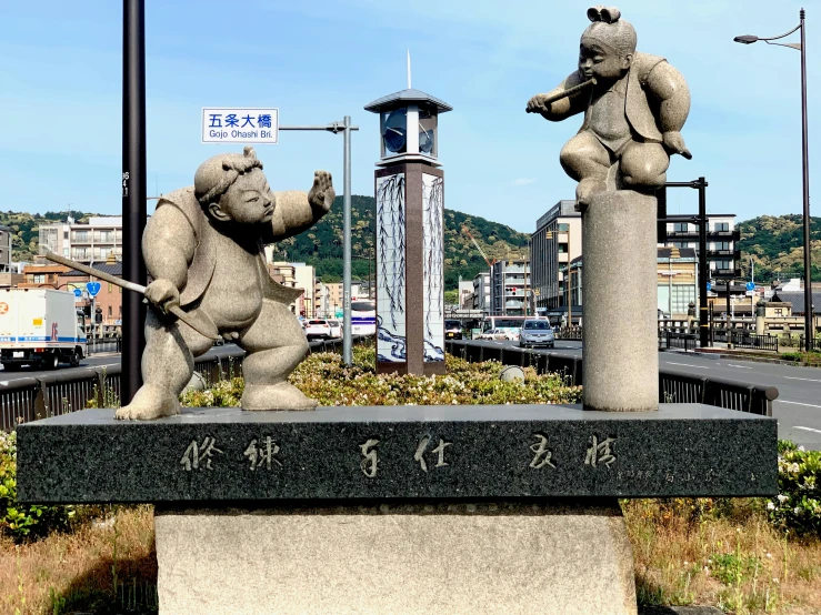 a sculpture of two big teddy bears in a park