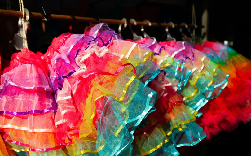 several colorful items hanging up on a rack