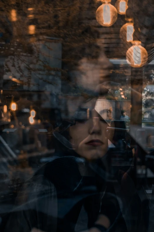 the reflection of a woman in a window is seen