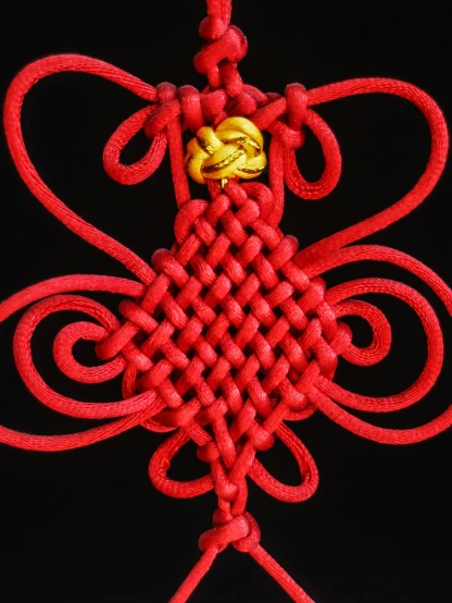 the intricate design is red with a gold knot around it