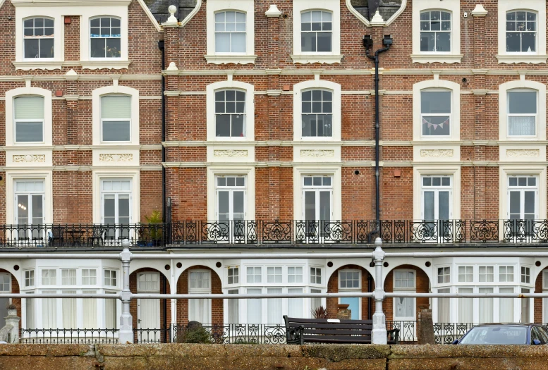 the building is tall and has an iron railing on it