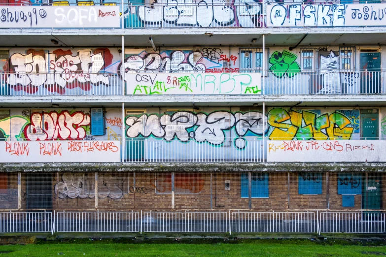 a very colorful apartment building with lots of graffiti