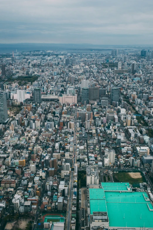 an aerial s of the city of a town with a tennis court