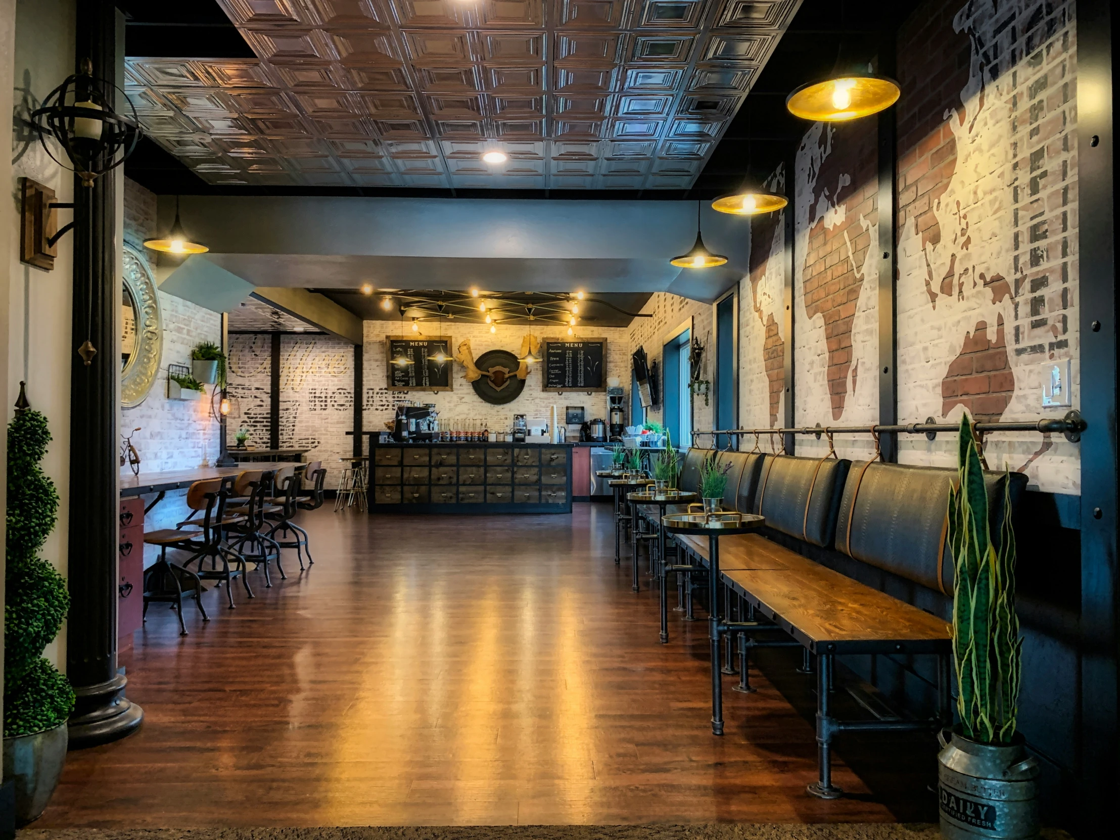 the inside of a restaurant with large windows, tables and benches